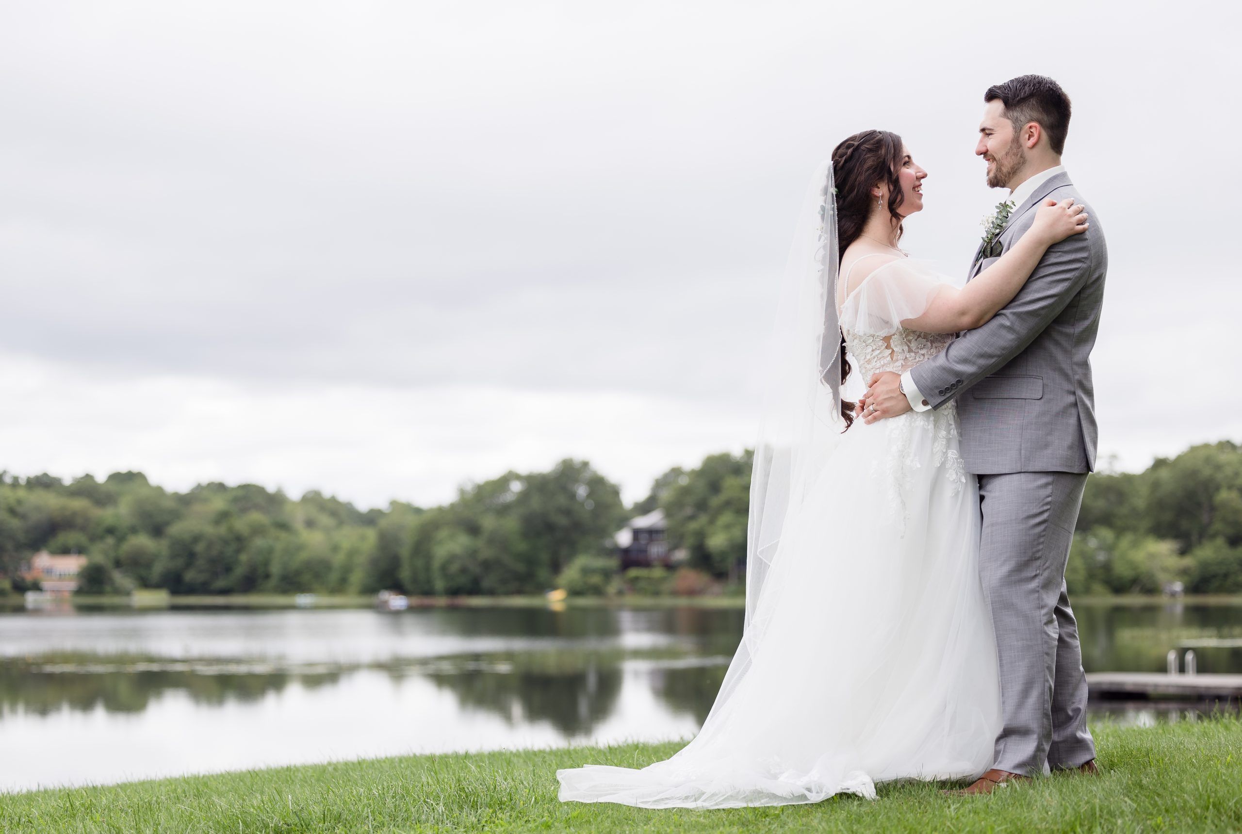 Bride and groom with pond in background.