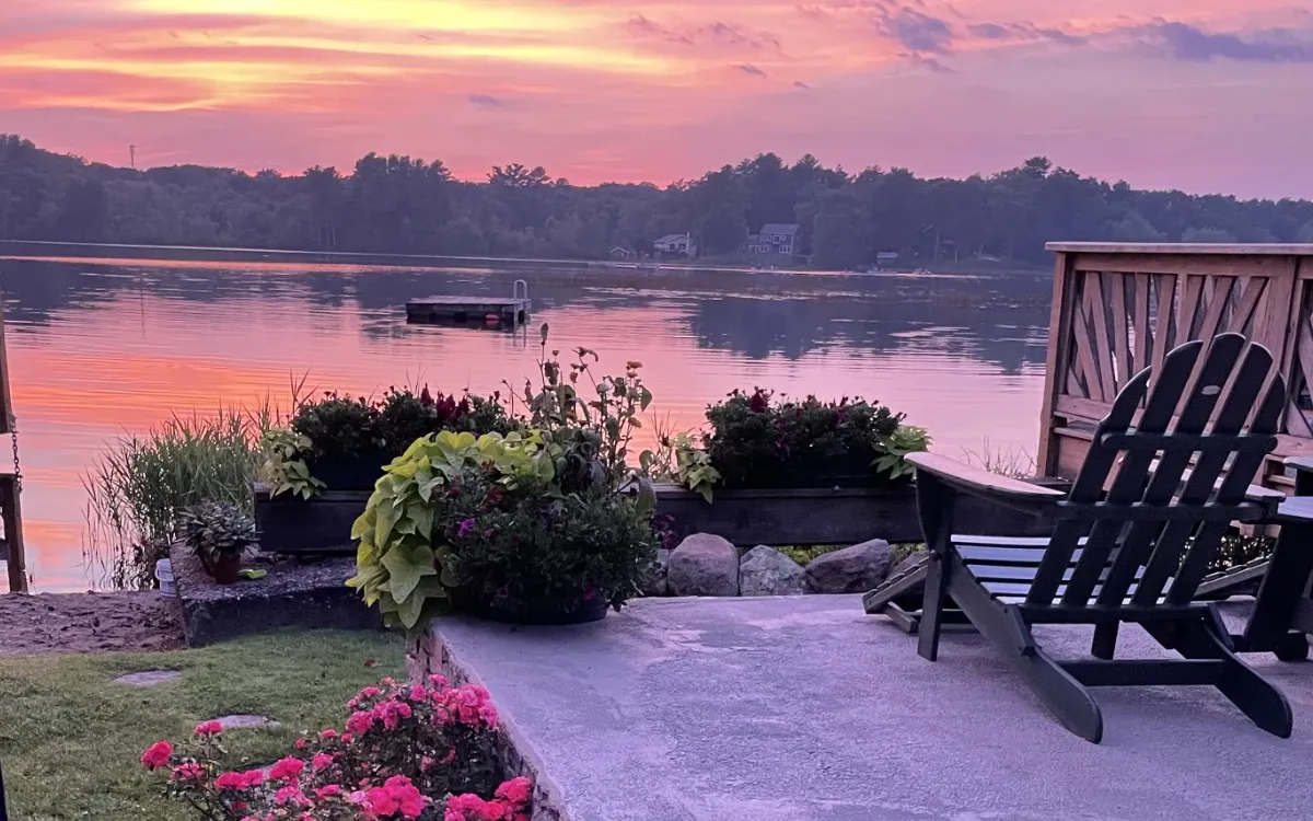 Chair on lakeside at sunset